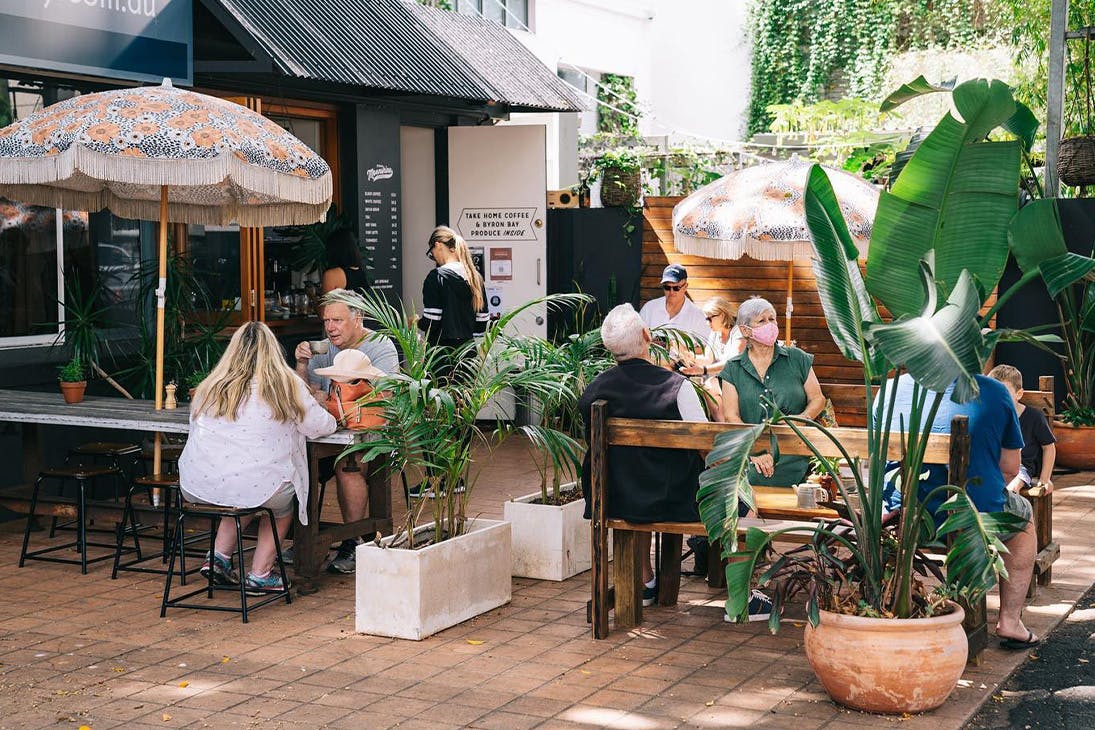 people sitting at picnic tables outside a kangaroo point cafe